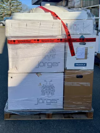 Palette mit originalverpackter Badkeramik der Marke Jörger, foliert und mit „Vorsicht Glas“-Band gesichert