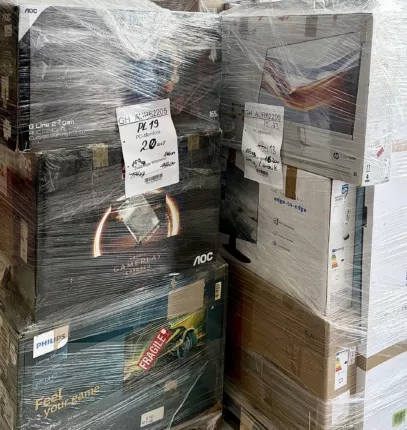 Nahaufnahme gestapelter Gaming- und Office-Monitor-Kartons auf einer folierten Palette